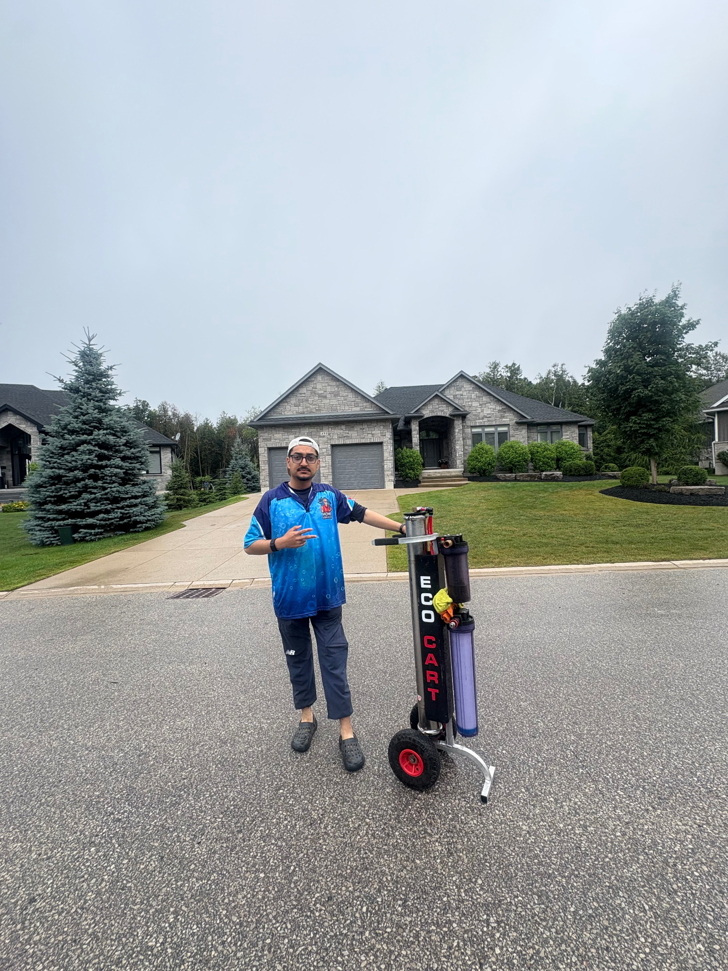 Top Tier Home Services technician with pure water cleaning cart outside a home